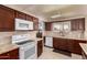 Bright kitchen with modern appliances, wooden cabinets, and a view to the exterior at 10809 W El Dorado Dr, Sun City, AZ 85351