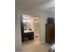 View of a vanity area with a walk-in shower and a cabinet for storage, and a built-in desk at 10822 W Mimosa Dr, Sun City, AZ 85373