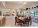 Bright dining room adjacent to kitchen and patio with tile floors at 10822 W Mimosa Dr, Sun City, AZ 85373