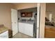 Convenient laundry closet with washer, dryer, and some storage at 10822 W Mimosa Dr, Sun City, AZ 85373