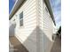 Angle view of the home's light-colored siding with visible windows at 111 S Greenfield Rd -- # 462, Mesa, AZ 85206