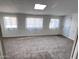 Finished basement with carpet, neutral walls, and ample lighting from three windows at 11223 W Missouri Ave, Youngtown, AZ 85363