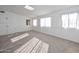 Bright bedroom with neutral carpet, white walls, closet and natural light at 11223 W Missouri Ave, Youngtown, AZ 85363