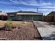 Modest single-story home with desert landscaping and a covered porch at 11223 W Missouri Ave, Youngtown, AZ 85363