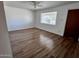 Bright living room featuring hardwood floors, neutral paint, and a ceiling fan at 11223 W Missouri Ave, Youngtown, AZ 85363