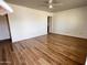 Spacious living room with sleek hardwood floors and lots of natural light at 11223 W Missouri Ave, Youngtown, AZ 85363