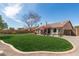 Large backyard showcasing a well-maintained lawn and a patio, framed by a decorative brick border at 11445 S 44Th St, Phoenix, AZ 85044