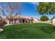 Expansive backyard featuring a lush green lawn and a cozy patio area, perfect for outdoor gatherings at 11445 S 44Th St, Phoenix, AZ 85044