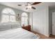 Well-lit bedroom with a closet, shuttered windows, and a ceiling fan at 11445 S 44Th St, Phoenix, AZ 85044