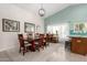 Bright dining area with a large area rug, modern light fixture, and a large window at 11445 S 44Th St, Phoenix, AZ 85044