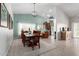 Inviting dining room with modern light fixture, large window, and open to the kitchen area at 11445 S 44Th St, Phoenix, AZ 85044