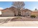 Charming one-story home featuring a neutral exterior, manicured landscaping, and a two-car garage at 11445 S 44Th St, Phoenix, AZ 85044