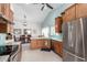 Open kitchen and dining area features stainless appliances, and eat-in kitchen island and dining table at 11445 S 44Th St, Phoenix, AZ 85044