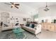 Bright and airy living room showcasing tile floors, comfortable seating, and a view into the dining area at 11445 S 44Th St, Phoenix, AZ 85044