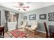 Bright sitting room featuring hardwood floors, area rug, and a ceiling fan at 11445 S 44Th St, Phoenix, AZ 85044