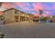 Expansive backyard featuring a built-in grill, a stone fire pit, covered patios, and manicured landscaping at 11965 W Monte Vista Rd, Avondale, AZ 85392