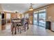 Bright dining area featuring a decorative chandelier, elegant dining set, and sliding doors to a backyard at 11965 W Monte Vista Rd, Avondale, AZ 85392