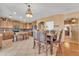 Spacious dining area connected to the kitchen, featuring a decorative light fixture and elegant wood dining set at 11965 W Monte Vista Rd, Avondale, AZ 85392