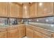 Detailed view of a well-equipped kitchen with granite countertops, mosaic backsplash, and custom wood cabinetry at 11965 W Monte Vista Rd, Avondale, AZ 85392