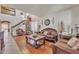 Elegant living room with a Christmas tree, featuring ornate furniture and a staircase with festive garland at 11965 W Monte Vista Rd, Avondale, AZ 85392