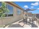 Relaxing outdoor patio featuring a table, chairs, and shade umbrella, ideal for outdoor entertaining at 11965 W Monte Vista Rd, Avondale, AZ 85392