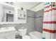 Cozy bathroom featuring a shower-tub combo with grey tile walls at 12220 N Escobar Way, Phoenix, AZ 85022