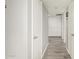 Hallway with wood-look floors and white doors at 12220 N Escobar Way, Phoenix, AZ 85022