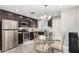 Modern kitchen featuring stainless steel appliances, dark cabinets, and wood floors at 12220 N Escobar Way, Phoenix, AZ 85022