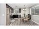 A kitchen dining area with stainless steel appliances and gray wood-look flooring at 12220 N Escobar Way, Phoenix, AZ 85022