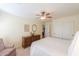 Bright bedroom with a ceiling fan and a classic wood dresser, offering a cozy retreat at 127 S Hancock Trl, Casa Grande, AZ 85194