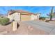 Single-story home showing desert landscaping and the two-car garage at 127 S Hancock Trl, Casa Grande, AZ 85194