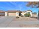 Charming single-story home featuring desert landscaping, a tan stucco exterior, and a two-car garage at 127 S Hancock Trl, Casa Grande, AZ 85194