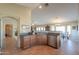 Open concept kitchen with stainless steel appliances and convenient breakfast bar at 127 S Hancock Trl, Casa Grande, AZ 85194