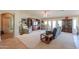 Large living room with a media center, plush seating, and sliding glass doors to the outdoor area at 127 S Hancock Trl, Casa Grande, AZ 85194