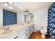 Well-lit bathroom with double sinks, modern fixtures, and a stylish shower curtain at 1309 E Echo Ln, Phoenix, AZ 85020