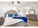 Bedroom featuring a large bed with blue accents and tile floors at 1309 E Echo Ln, Phoenix, AZ 85020