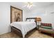 Comfortable bedroom featuring a ceiling fan, neutral color palette, and light tile floors at 1309 E Echo Ln, Phoenix, AZ 85020