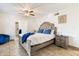 Bedroom with a large bed, tile floors, and an ensuite bathroom in the background at 1309 E Echo Ln, Phoenix, AZ 85020