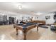 Spacious game room with pool table, media, and an adjacent seating area with tan leather sectional sofa at 1309 E Echo Ln, Phoenix, AZ 85020