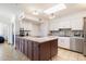 Bright kitchen with a large island, white cabinets, and stainless steel appliances at 1309 E Echo Ln, Phoenix, AZ 85020