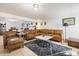 Inviting living room features a plush leather sectional, stylish rug, and a comfortable armchair with ottoman at 1309 E Echo Ln, Phoenix, AZ 85020