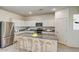 Well-lit kitchen with stainless steel appliances, granite counters, a kitchen island, and bar stool seating at 13123 E Verbina Ln, Florence, AZ 85132