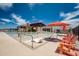 Community pool with a splash pad, lounge chairs, and colorful umbrellas at 13123 E Verbina Ln, Florence, AZ 85132