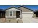 Single-story home with a two-car garage, a stone-accented facade, and low-maintenance desert landscaping at 13142 E Verbina Ln, Florence, AZ 85132