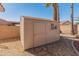 Backyard storage shed, set on a graveled area of the home's lot and near mature shade trees at 13208 W Desert Rock Dr, Surprise, AZ 85374