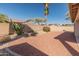 Desert landscaped backyard with block wall providing privacy at 13208 W Desert Rock Dr, Surprise, AZ 85374