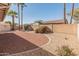 Backyard featuring desert landscaping, brick wall, shed, and shade trees on a sunny day at 13208 W Desert Rock Dr, Surprise, AZ 85374