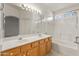 Bathroom features double sink vanity, large mirror, and shower-tub combo at 13208 W Desert Rock Dr, Surprise, AZ 85374