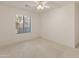 Simple bedroom with plush carpeting, white walls, and a window with pleated blinds at 13208 W Desert Rock Dr, Surprise, AZ 85374