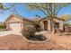 Inviting single-story home with a well-maintained front yard, desert landscaping, and a two-car garage at 13208 W Desert Rock Dr, Surprise, AZ 85374